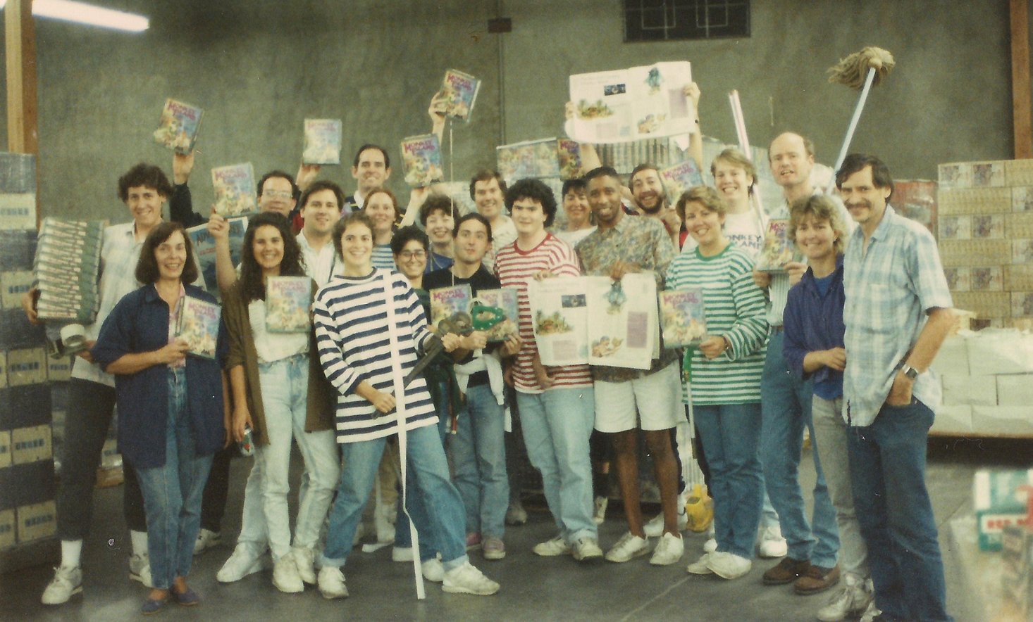 The LucasArts team packing boxes of The Secret of Monkey Island for shipment, c. 1990. Among them: Ron Gilbert, Tim Schafer, Dave Grossman, Steve Purcell, Mark Ferrari, and the rest of the crew who built a genre-defining classic. (Photo: MixnMojo)